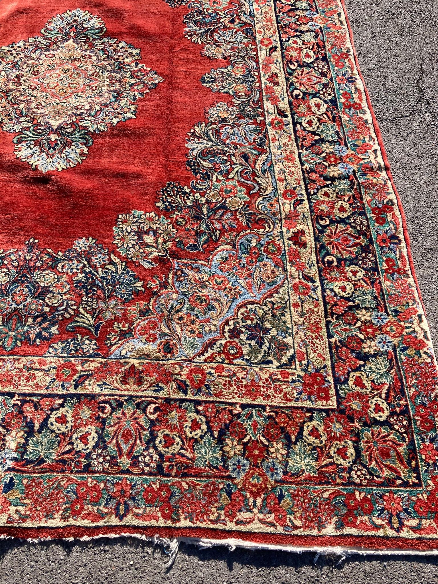 A large North West Persian red ground carpet, 361cm x 274cm